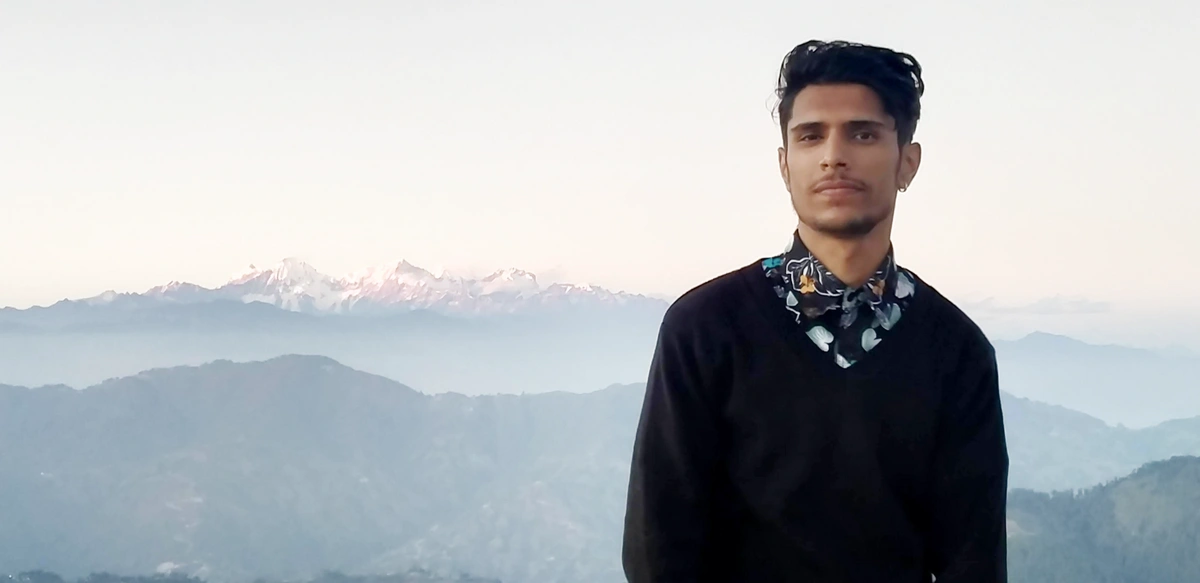 Young remote working man with mountains in the background