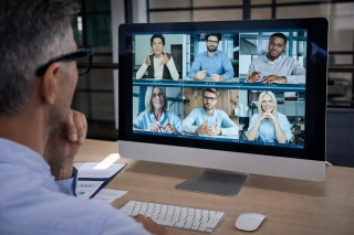 Global remote team collaborating through video call with an international remote hiring agency