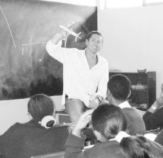 Geoff Hucker, founder of Work for Impact, speaking to children at a school